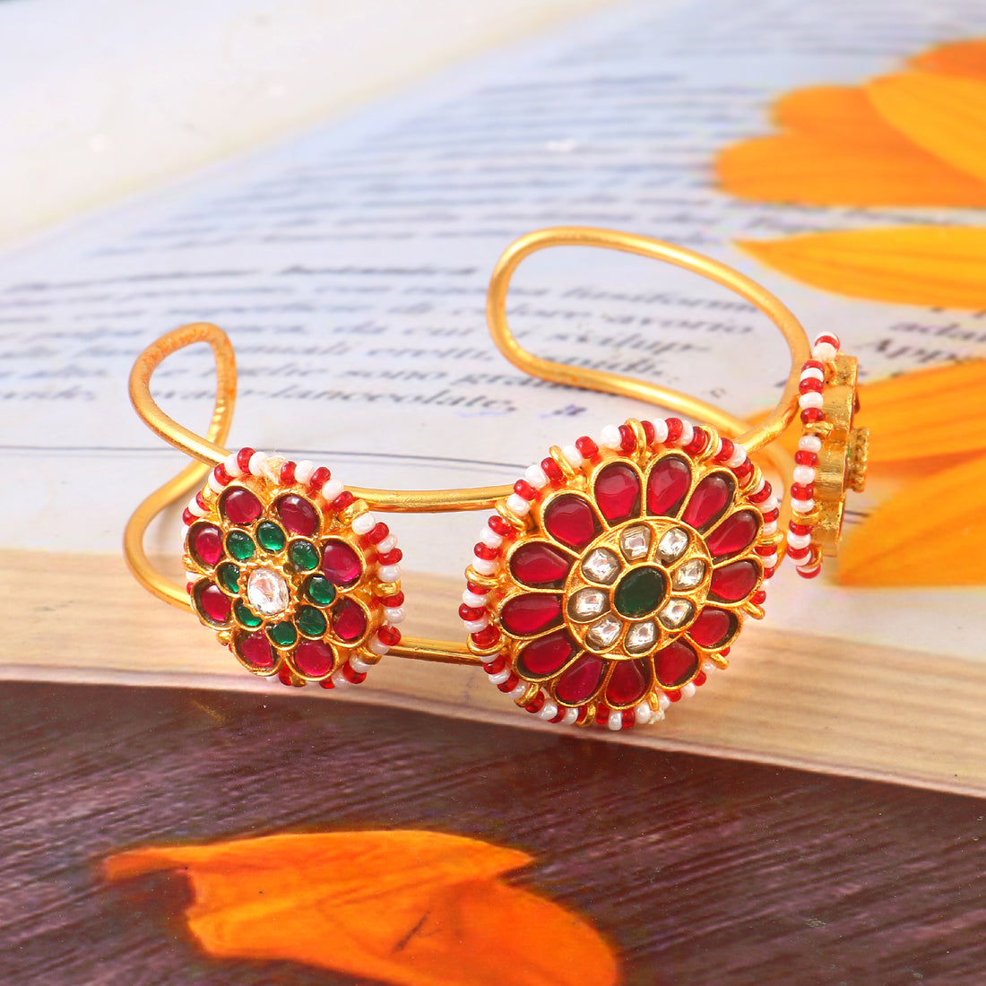 Elegant Gold Jadau Kundan Bangle with Red Floral Design and Green Center Stones.